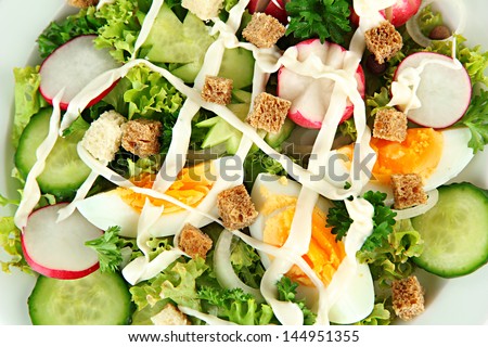 Fresh mixed salad with eggs, salad leaves and other vegetables, close up