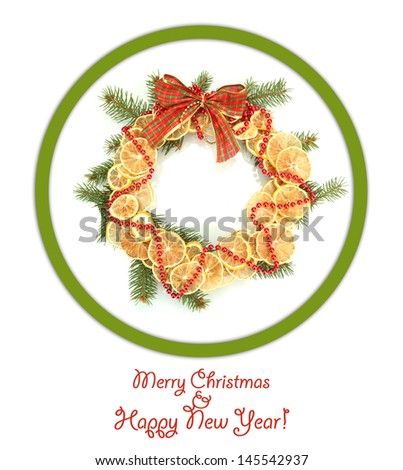Christmas wreath of dried lemons with fir tree and bow isolated on white