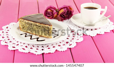 Delicious poppy seed cake with cup of coffee on table close-up