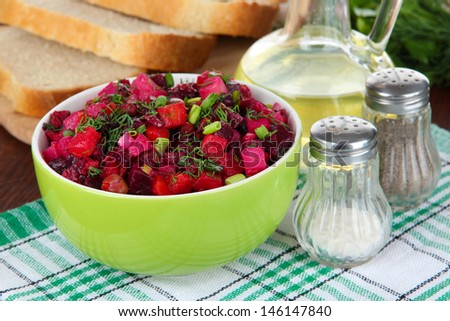 Beet salad in bowl on table close-up