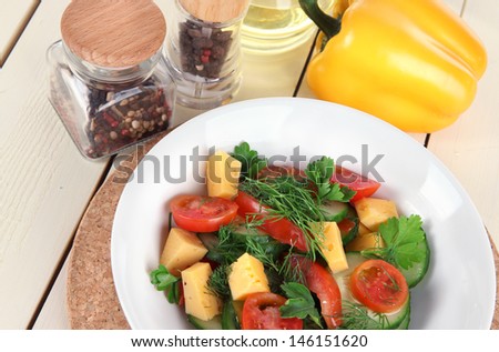 Light salad in plate on wooden table