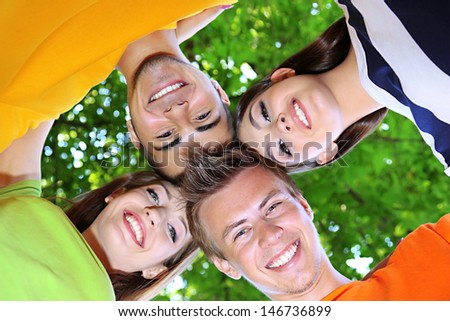 Happy group of young people in park