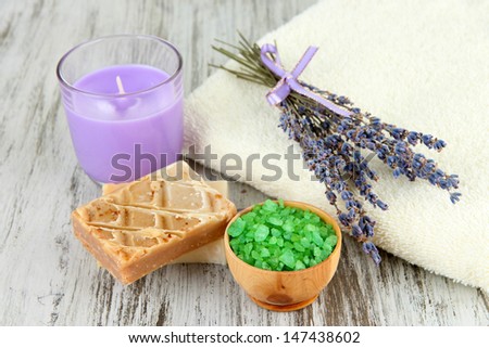 Still life with lavender candle, soap,   soap and fresh lavender, on wooden background