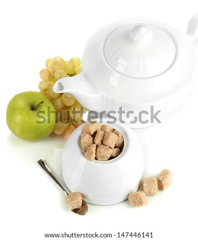 Unrefined sugar in white sugar bowl on grey background