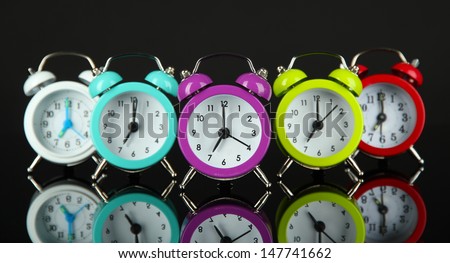 Colorful alarm clock on dark grey background