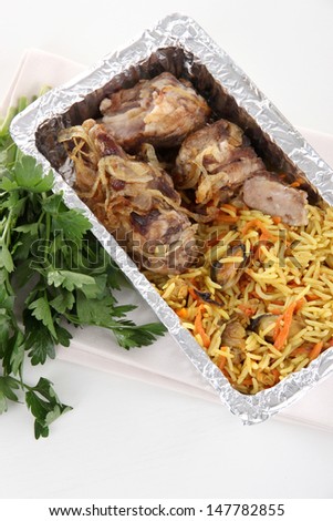 Food in box of foil on napkin  isolated in white
