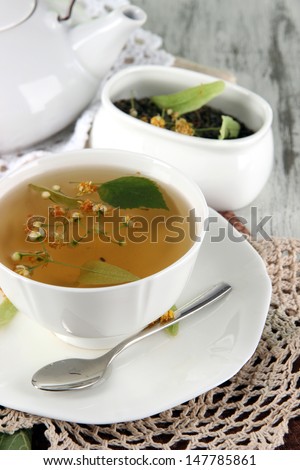 Cup of tea with linden on napkins on    wooden table