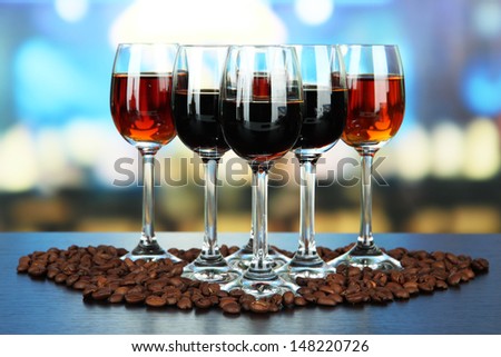 Glasses of liquors, on bright background