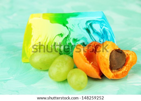 Piece of handmade soap with fruit flavor, on bright background