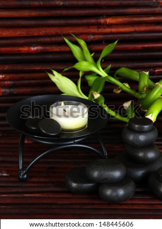 Spa stones and bamboo on bamboo mat background