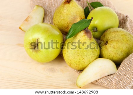 Pears on burlap on wooden table