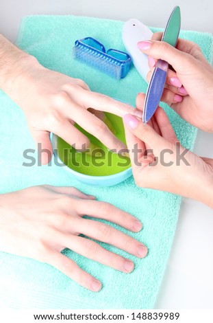 Man doing manicure in salon