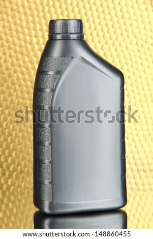 Canister with machine oil on color background