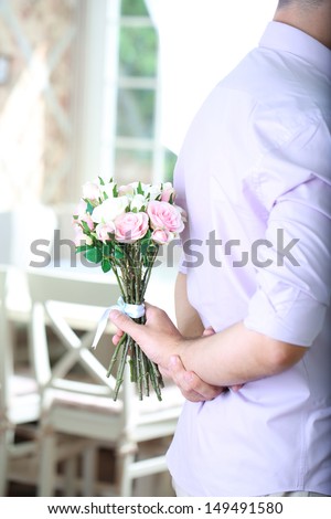 Handsome man with bouquet roses for his girlfriend