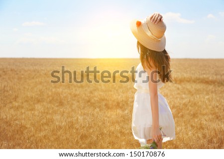 Portrait Of Beautiful Young Woman With Flowers In The Field