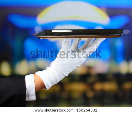 Empty tray in hand waiter on restaurant background