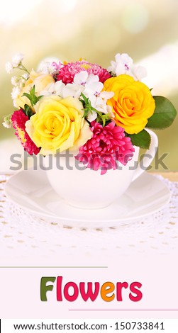 Beautiful bouquet of bright flowers in mug on bright background