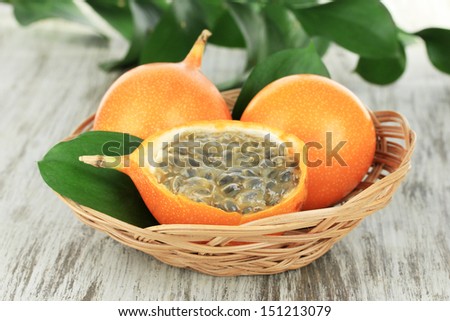 Passion fruits in wicker basket on table close-up