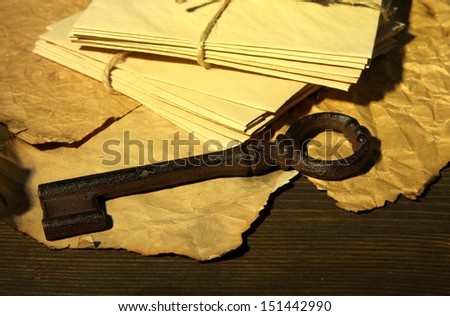 Antique key and letters on dark background