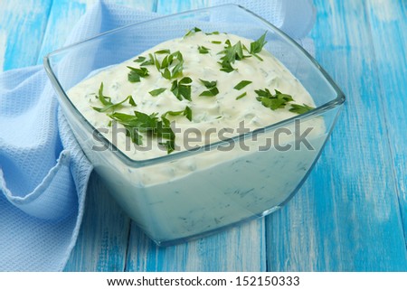Sour cream in bowl on table close-up