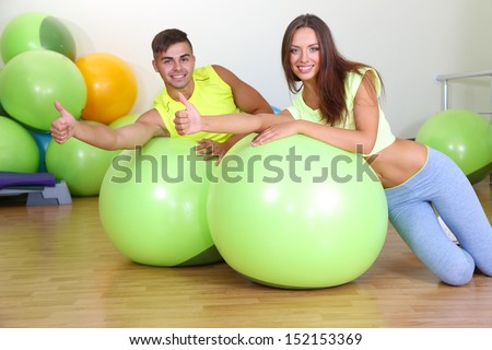 Girl and guy in fitness room