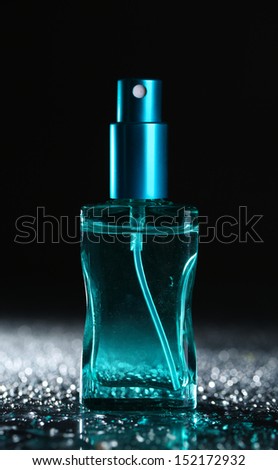 Women perfume in beautiful bottle on dark background