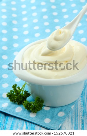 Sour cream in bowl on table close-up