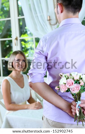 Handsome man with bouquet roses for his girlfriend