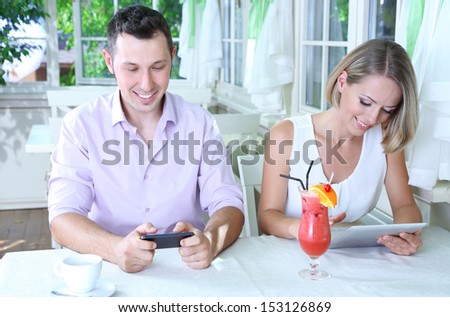 Young couple  taking  with tablet in restaurant