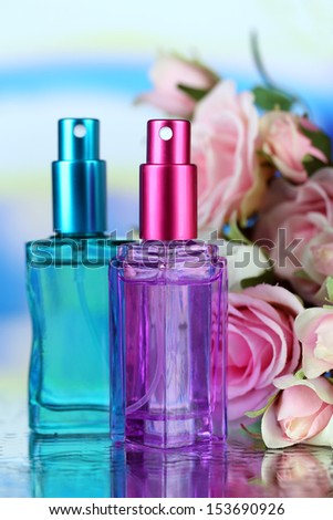 Women perfume in beautiful bottles and flowers