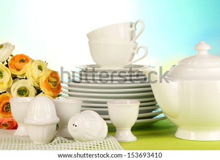 beautiful dishes on wooden table on bright background