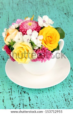 Beautiful bouquet of bright flowers in color vase,  on bright background