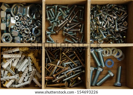 Wooden box for metal bolts, screws and nuts close up