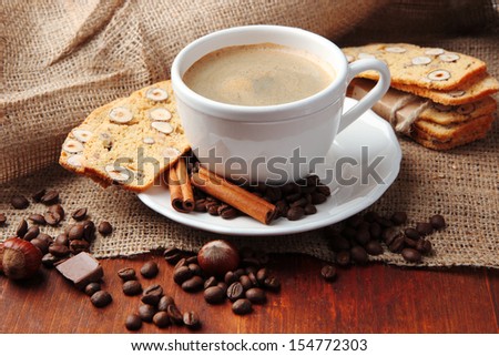 Cup of tasty coffee with tasty Italian biscuits, on wooden background