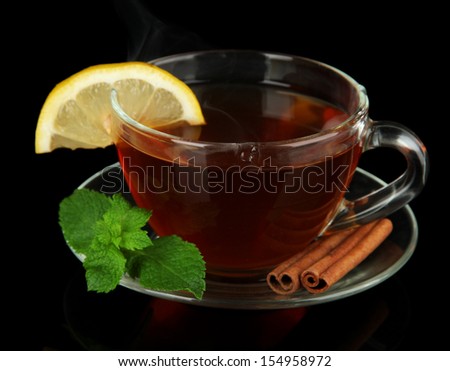 Cup of tea with lemon isolated on black