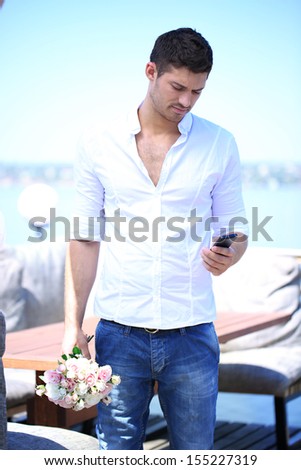 Handsome with bouquet of roses man waiting a woman
