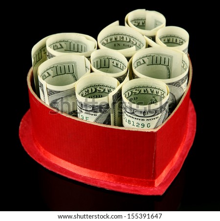 Money in gift box on dark color  background