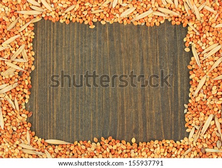 Food for parrots on wooden background
