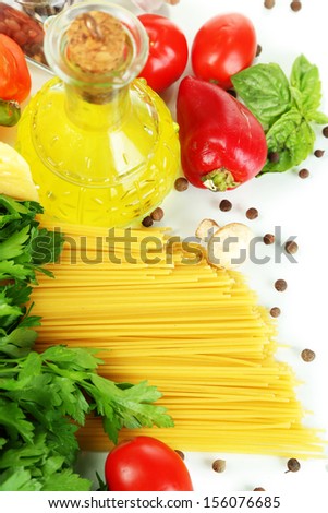 Pasta spaghetti with spices, oil and vegetables isolated on white