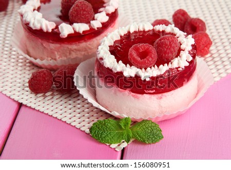 Delicious berry cakes on table close-up