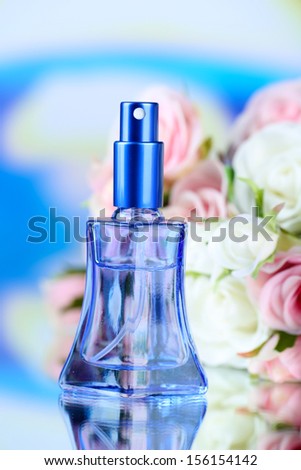 Women perfume in beautiful bottle and flowers