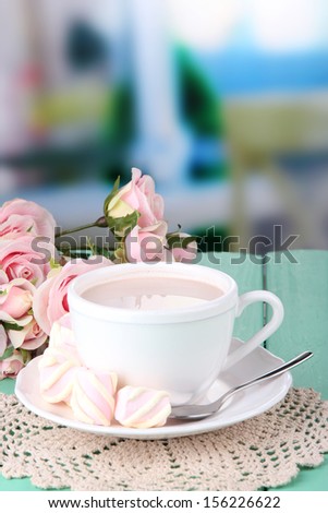 Cocoa drink on wooden  table, on bright background
