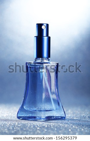 Women perfume in beautiful bottle on blue background