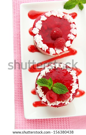 Delicious berry cakes on plate close-up