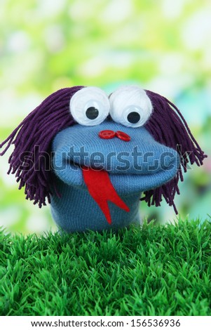 Cute sock puppet on bright background