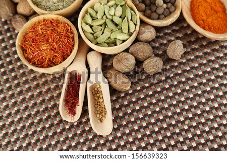 Many different spices and fragrant herbs on wooden table close-up