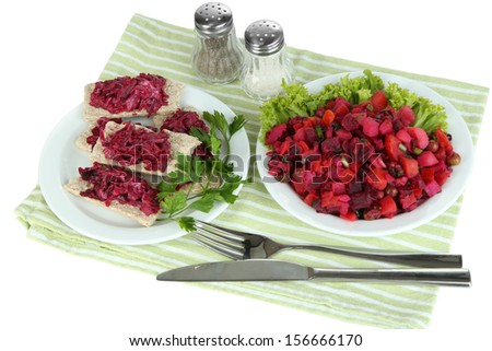 Beet salad on toasts and on plate isolated on white