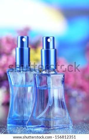 Women perfume in beautiful bottles and flowers