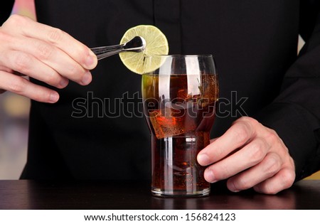 Bartender making cocktail on bright background, close-up