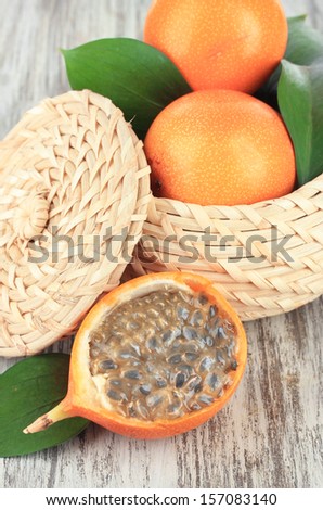 Passion fruits in wicker basket on table close-up